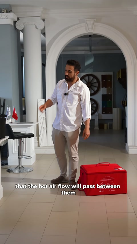 Presenter directs attention to red case after releasing black pieces.