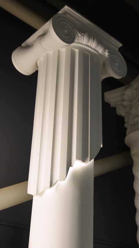 Un fusto di colonna decorativa scanalato e un capitello ionico sono mostrati in dettaglio