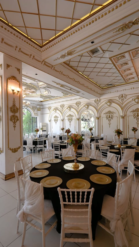Elegant ballroom with arched wall panels and layered ceiling cornices