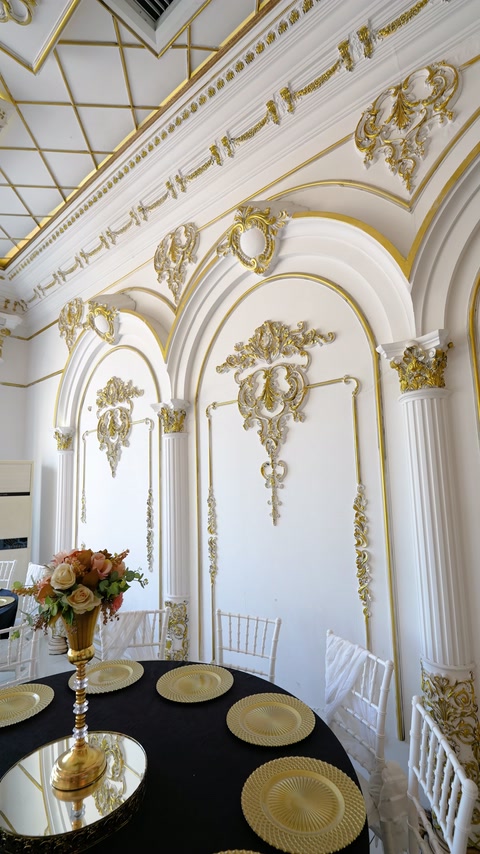 Gold relief ornaments accent tall arches and decorative wall mouldings