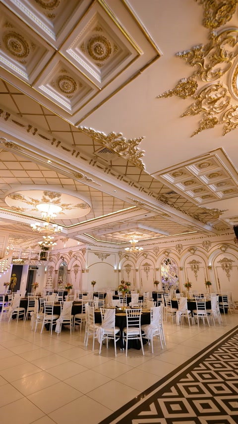 Coffered ceiling panels and gold mouldings span the spacious ballroom