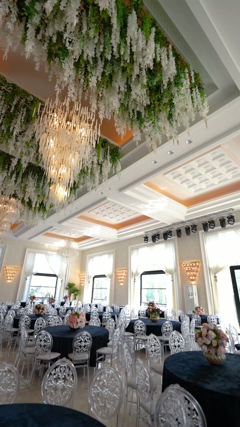 Modern reception hall features recessed ceiling panels and perimeter cornices