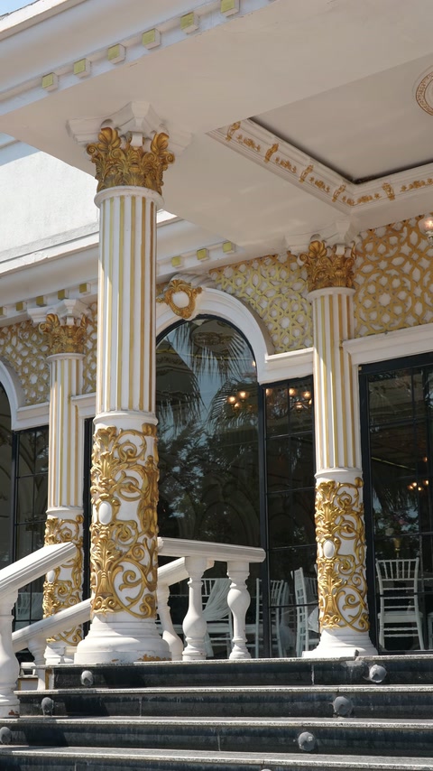 Close view shows ornate column bases, capitals and facade cornices