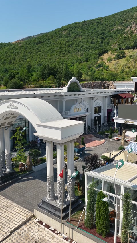 Elevated venue view reveals the columned entrance and curved exterior canopy