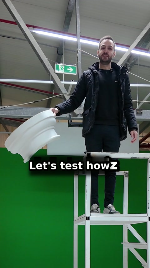 Presenter displays curved polyurethane moulding sections inside the production workshop