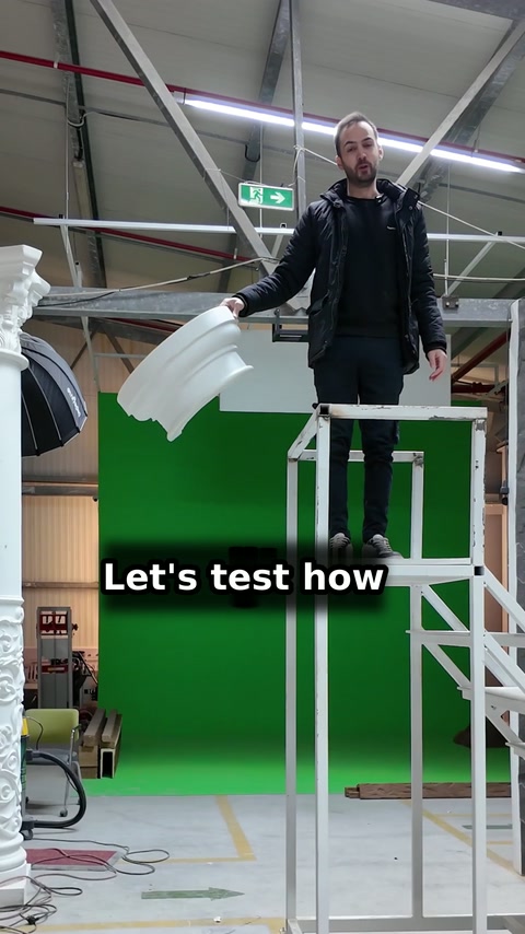 Presenter holds a white moulding before testing it from the platform