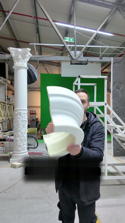Presenter turns the decorative profile while examining its smooth outer face