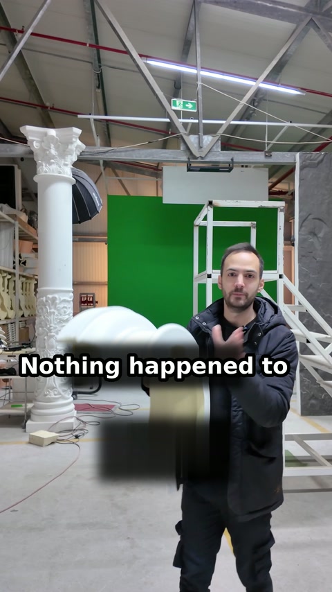 Curved moulding is held forward to show its condition after impact