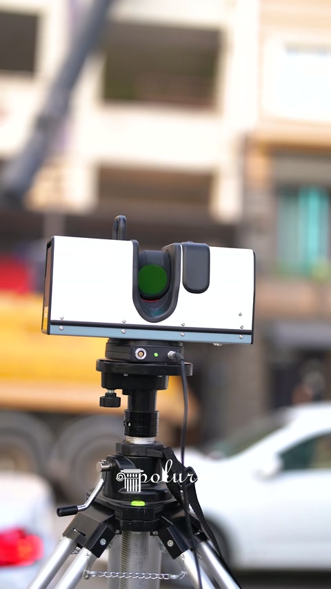 Three-legged scanning device positioned during measurement preparation outside the hall