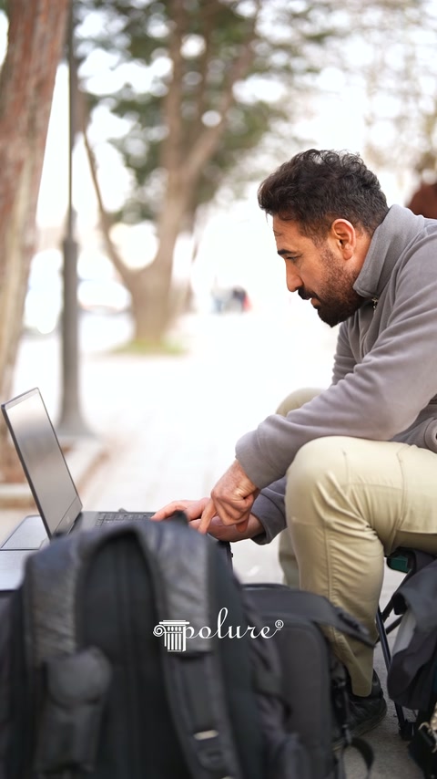 Technician examining scanning data on laptop during outdoor measurement work