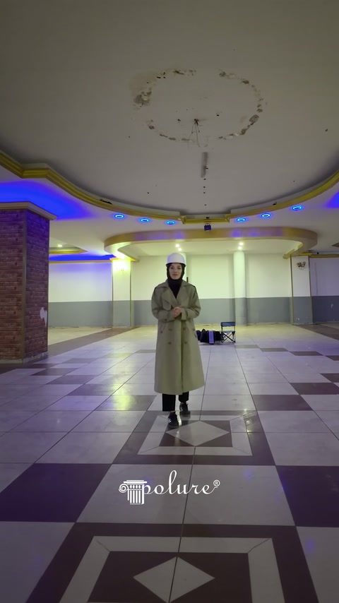 Hall interior before renovation showing plain ceiling and geometric floor covering