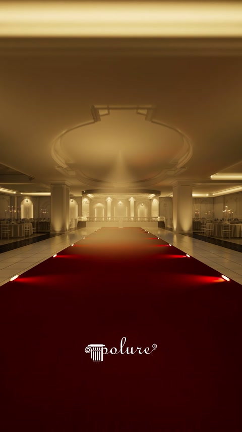 Arched stage surrounded by decorative columns with red runner at the end