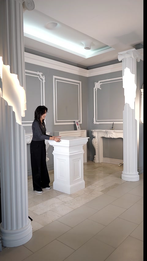 Square pedestal displays a projecting top and framed side panels.