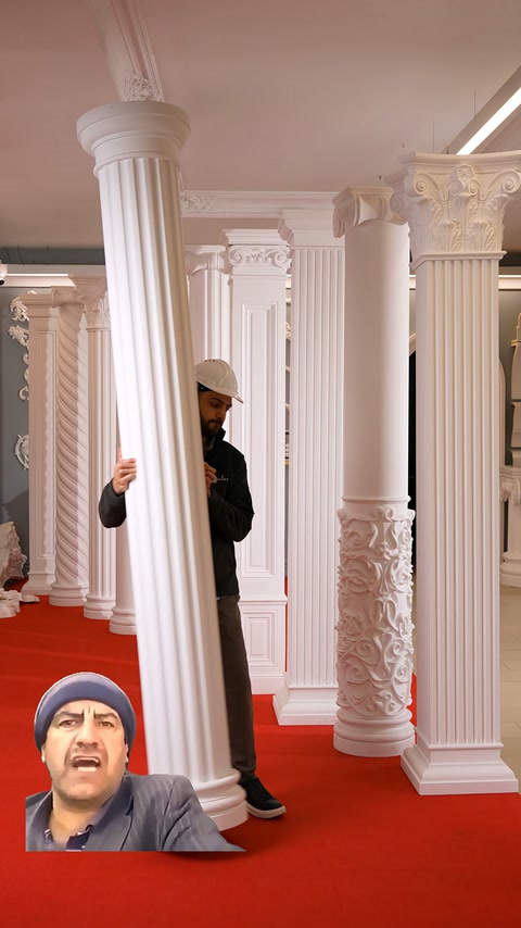 Attendant tilts forward a round-base fluted column to present its design features.