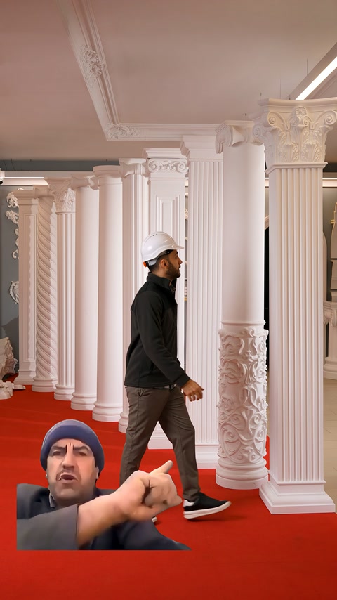 Attendant points closely to a column featuring an embossed base detail.