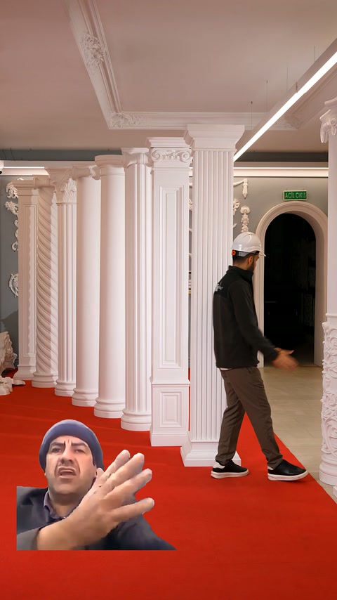Various columns and pilasters fill the red-carpeted display area.