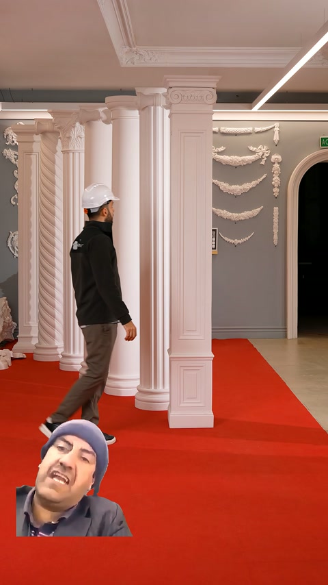 Two square pilaster models stand in comparison in front of round columns.