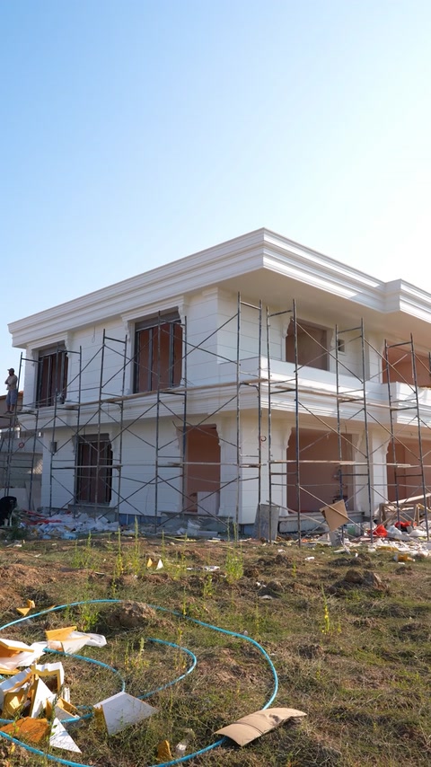 Villa under construction with scaffolding before facade molding installation