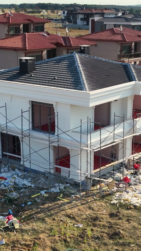Completed villa exterior showing columns and cornice from a distance