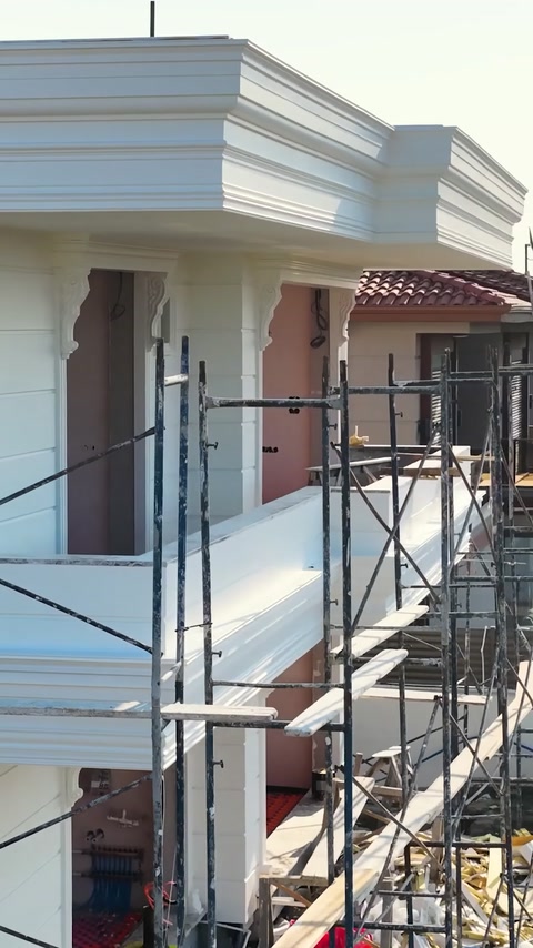 Scaffolding along villa balcony during polyurethane facade installation