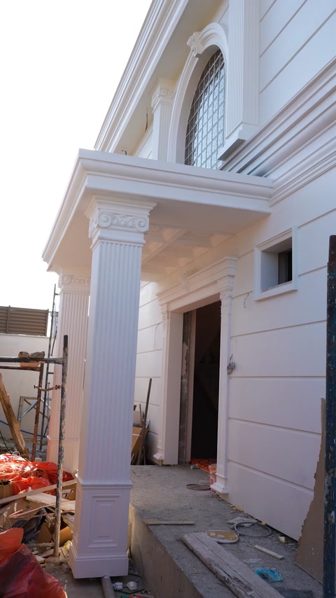 Column and pediment corner detail above entrance door