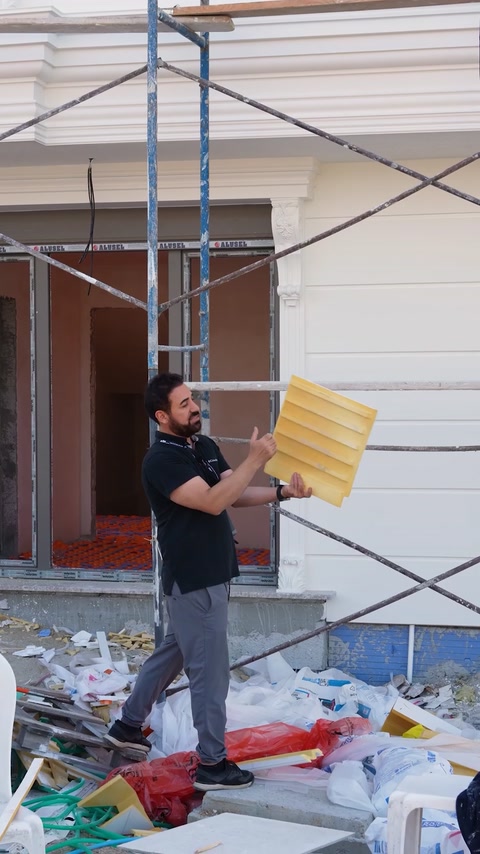 Presenter holding a curved flexible wall covering panel outdoors