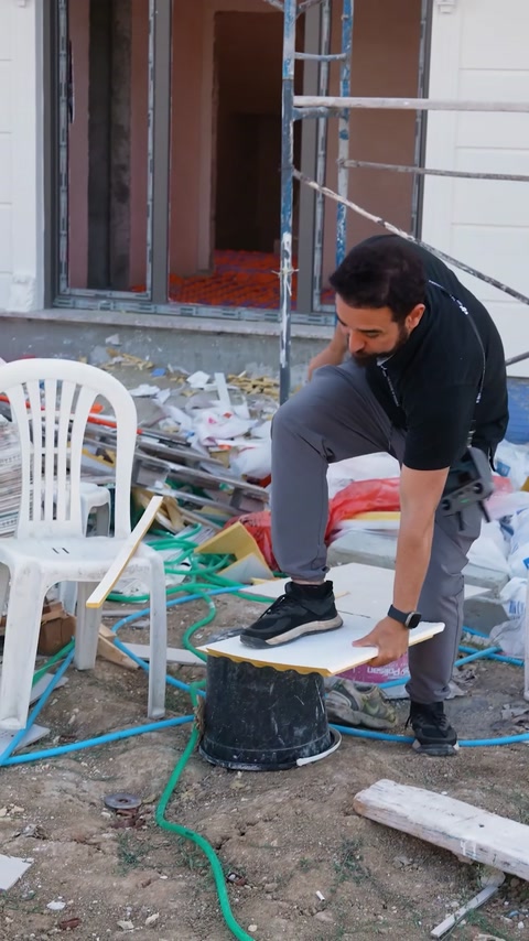 Man standing on molding piece to demonstrate its strength