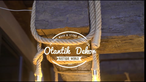 Decorative beam with warm-toned bulb suspended from rope underneath