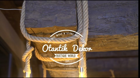 Thick rope-wrapped beam with decorative bulb lit below