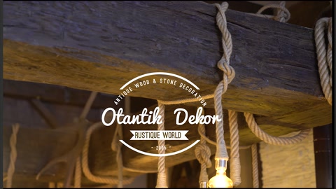 Rope-lit arrangement beneath dark ceiling beam