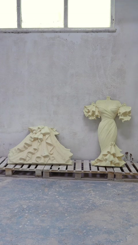 The machined wedding dress relief and decorative components are displayed side by side in the workshop.