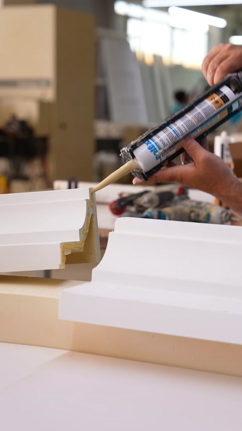 Adhesive is applied to the joining surface of the curved decorative profile components.