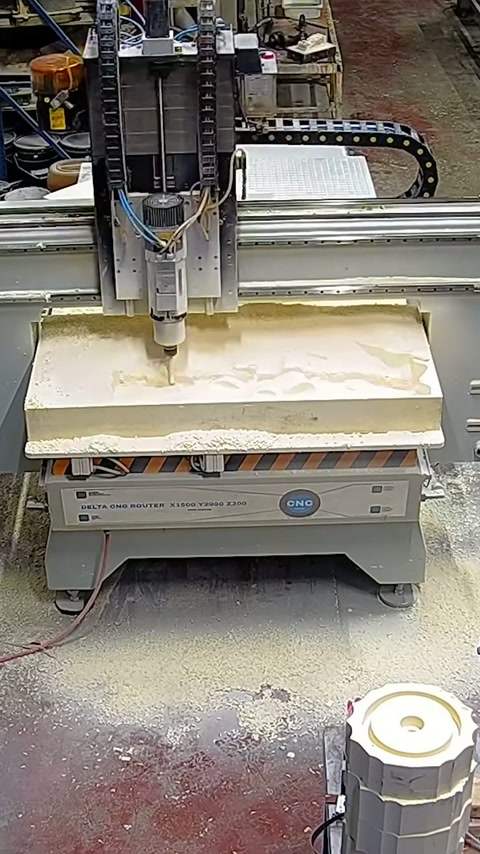 CNC machine begins processing relief form on thick foam block.