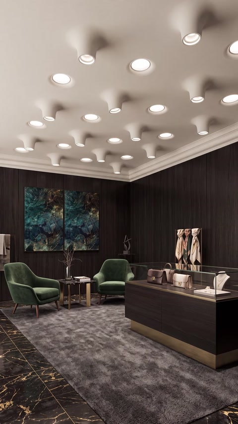 Elementi illuminanti scultorei a soffitto valorizzano un raffinato ambiente commerciale con cornici decorative