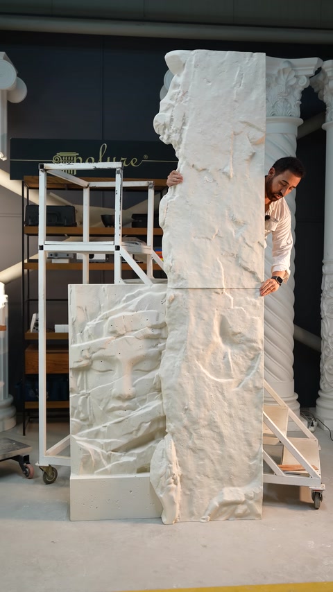 Large polyurethane relief piece held vertically in the production area