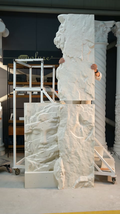 The vertically positioned relief section is aligned above the lower composition.