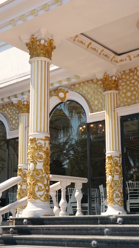 Golden botanical ornaments on fluted columns