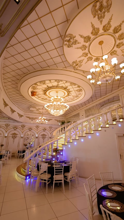 Circular ceiling medallion and illuminated curved staircase