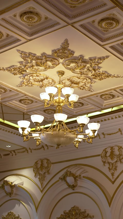 Embossed ceiling medallion and cornice details around chandelier
