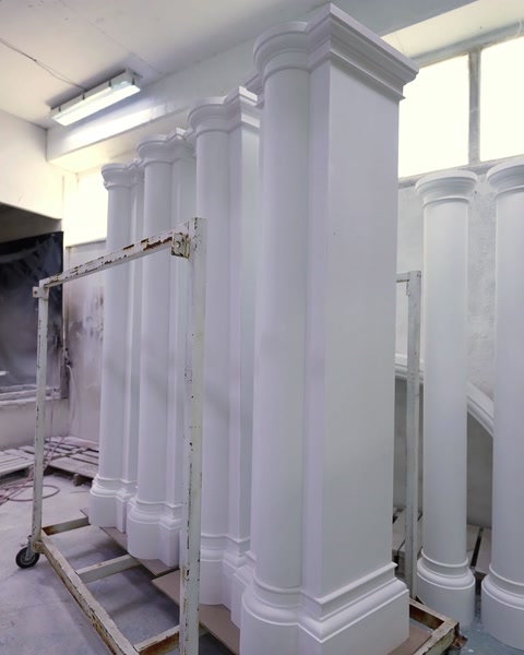 Physical showroom display presents fluted columns with decorative capitals