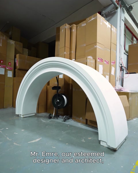 Ready-made curved arch pieces are displayed beside workshop equipment