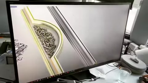Digital design details of a curved surround profile are examined on screen.