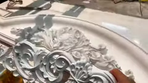 Embossed decorative polyurethane profile details are shown on a workshop bench.