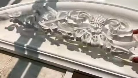 Surface details of a floral-motif exterior decoration are shown in close-up.
