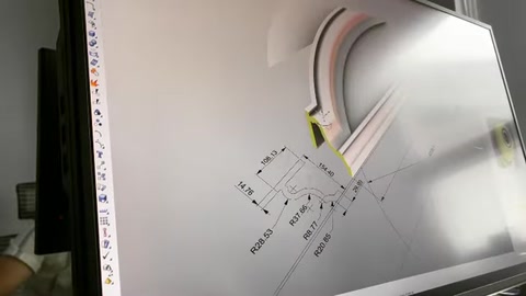 A dimensioned technical drawing of a curved window surround appears on the computer screen.