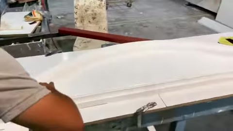A decorative surround piece is examined during the production stage on a workshop table.