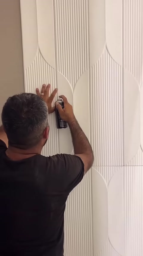 Fast-setting adhesive is carefully applied to the panel joint.
