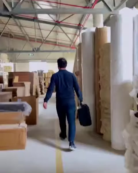 Production warehouse shelves hold stacked decorative molding elements