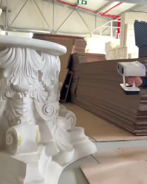 3D scanner records the surface of an ornate architectural piece