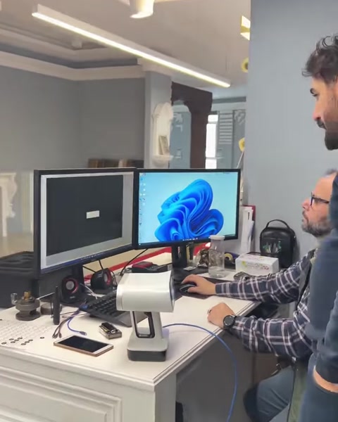 Design team reviews digital models at a workstation